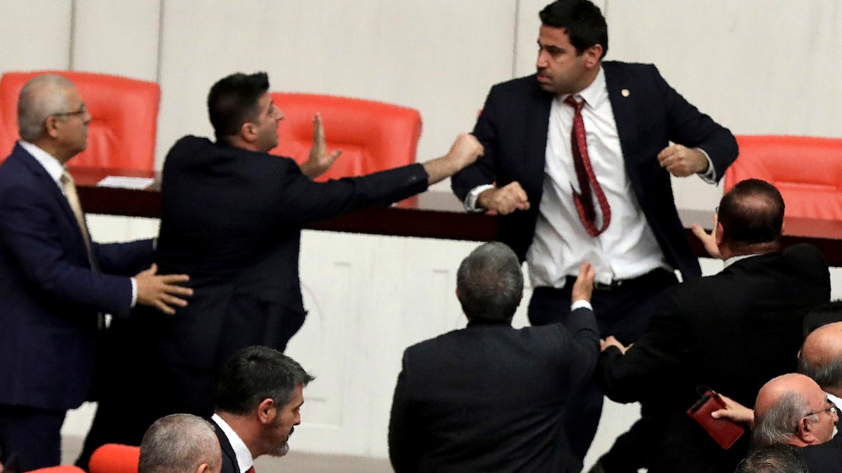 Legislators push each other as a brawl breaks out in Turkey's parliament in Ankara, Turkey, Wednesday, March 4, 2020. A fight broke out in the Turkish parliament between lawmakers from opposing parties during a tense discussion about Turkey's military involvement in northwest Syria. (AP Photo)