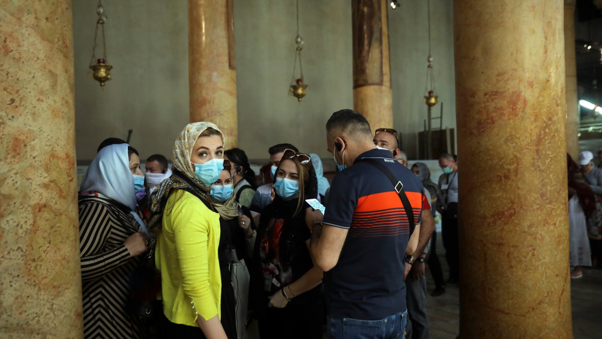 People visit the Church of the Nativity in Bethlehem, West Bank, Thursday, March 5, 2020. Palestinian authorities said the Church of the Nativity in Bethlehem, built atop the spot where Christians believe Jesus was born, will close indefinitely due to coronavirus concerns.