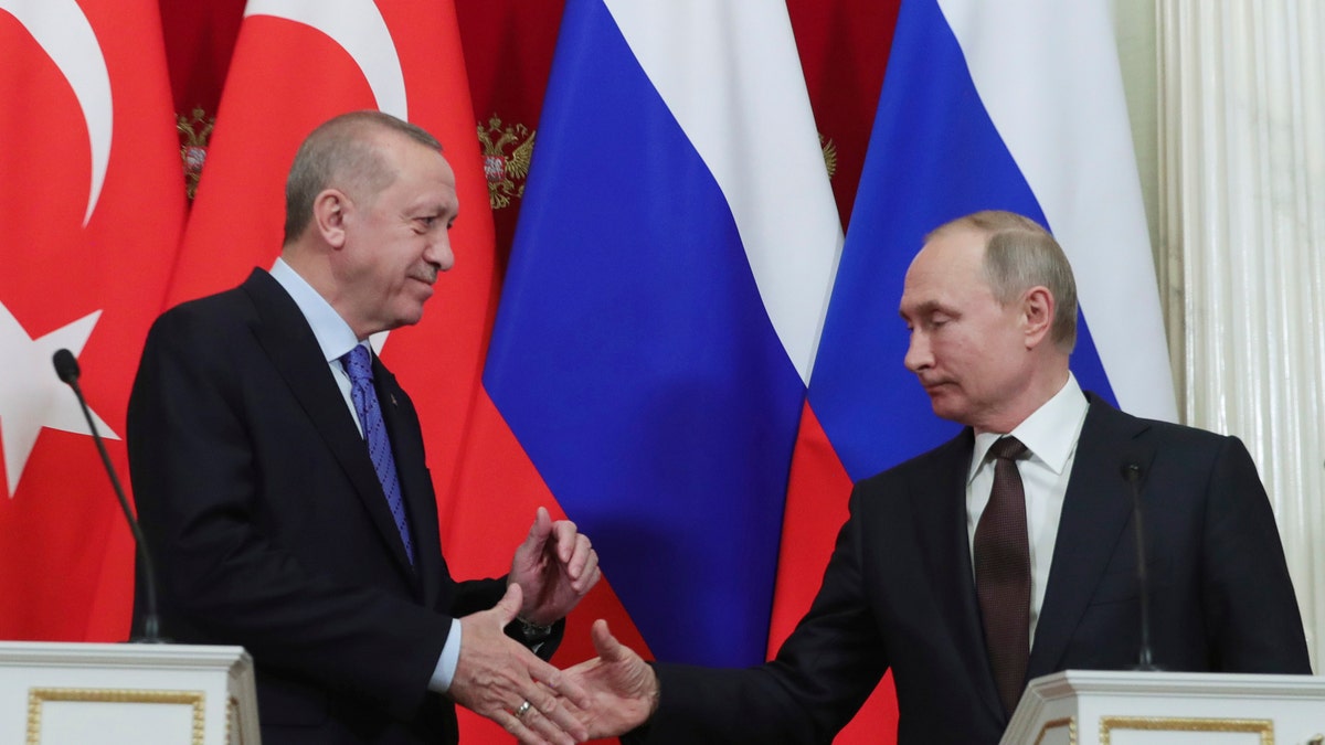 Russia's President Vladimir Putin, right, and Turkish President Recep Tayyip Erdogan shake hands after a joint news conference followed six-hour talks in the Kremlin, in Moscow, Russia, Thursday, March 5, 2020. (Presidential Press Service via AP, Pool)