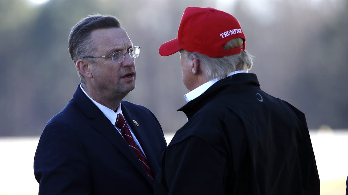 President Donald Trump greets Rep. Doug Collins, R-Ga., as he arrives on Air Force One Friday, March 6, 2020, at Dobbins Air Reserve Base in Marietta, Ga. (AP Photo/Alex Brandon)