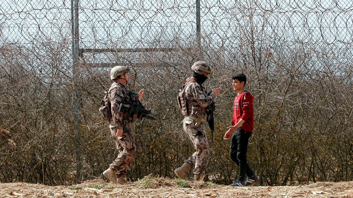 Turkish special police officers patrol by the fence on the Turkish-Greek border in Pazarkule, Turkey, Saturday, March 7, 2020. Thousands of migrants headed for Turkey's land border with Greece after Erdogan's government said last week that it would no longer prevent migrants and refugees from crossing over to EU territory. (AP Photo/Darko Bandic)