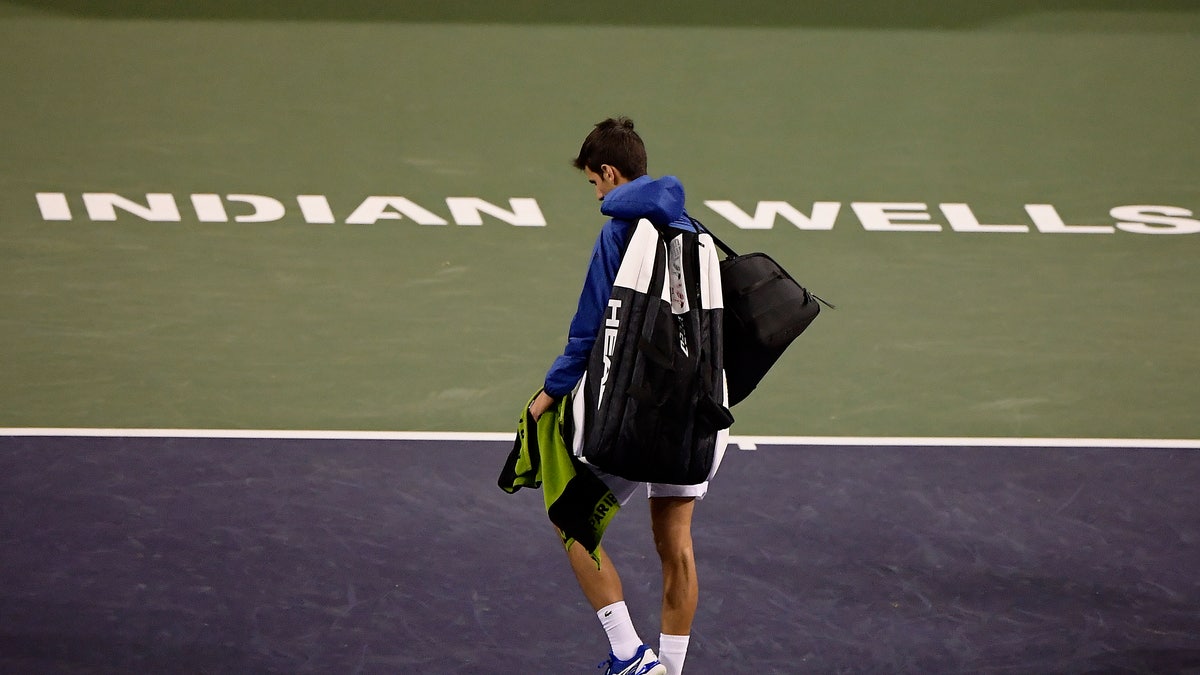 FILE - In this Monday, March 11, 2019, file photo, Novak Djokovic, of Serbia, walks off the court during a rain break in his match against Philipp Kohlschreiber, of Germany, at the BNP Paribas Open tennis tournament in Indian Wells, Calif. The BNP Paribas Open tennis tournament, set to begin Wednesday, March 11, 2020, has been postponed after a case of coronavirus was confirmed in the Coachella Valley. (AP Photo/Mark J. Terrill, File)