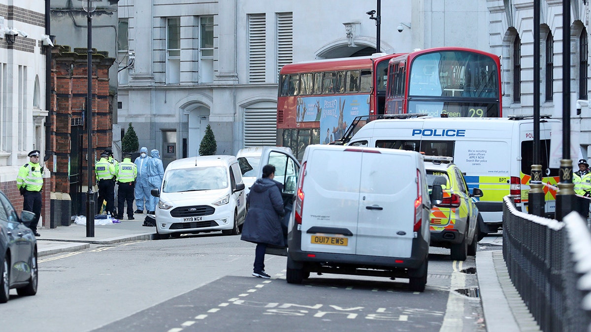 Police activity in Great Scotland Yard, in Whitehall, central London, near the area of an incident, in Whitehall, London, Monday, March 9, 2020. British police say they have shot dead a man who was brandishing two knives near Trafalgar Square in central London. The Metropolitan Police force said Monday that the shooting was not related to terrorism. (Yui Mok/PA via AP)