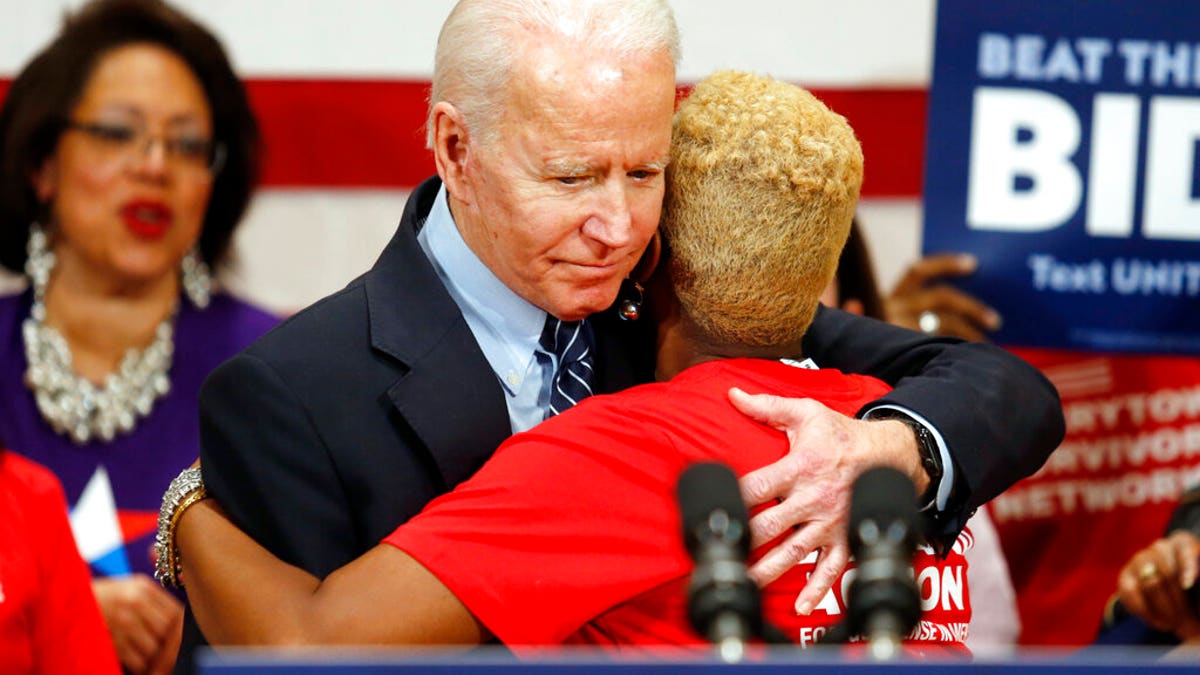 Democratic presidential candidate former Vice President Joe Biden hugs Crystal Turner of Columbus, Ohio, with Moms Demand Action during a campaign rally in Columbus, Ohio, Tuesday, March 10, 2020. (AP Photo/Paul Vernon)