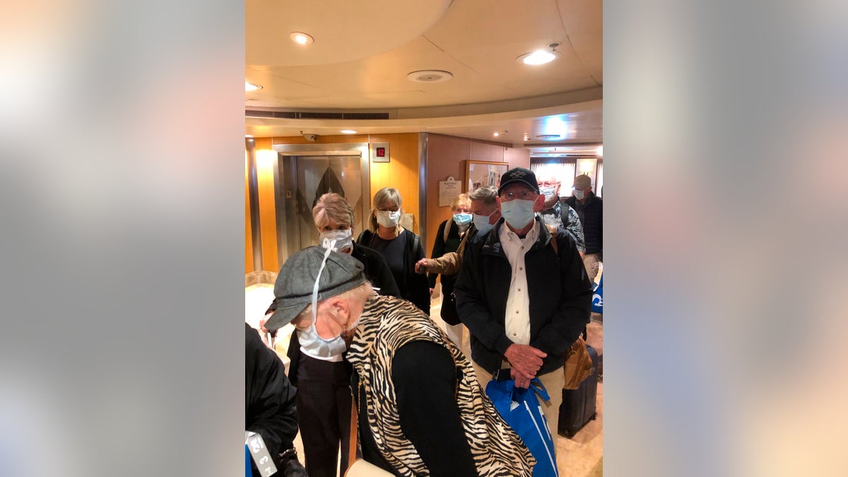 This photo provided by Laurie Miller shows passengers as they get ready to disembark the Grand Princess in Oakland, Calif., Tuesday, March 10, 2020. California Gov. Gavin Newsom urged the state's nearly 40 million residents to avoid sporting events, concerts and large gatherings to prevent the spread of the coronavirus and adamantly warned the elderly to stay away from cruise ships as he pondered measures to restrict cruise travel off the California coast. (Laurie Miller via AP)