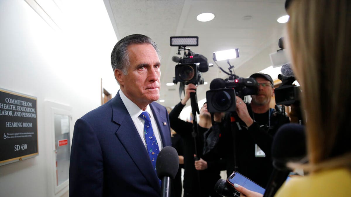 Sen. Mitt Romney, R-Utah, pauses to speak to media as he arrives for a briefing on Capitol Hill in Washington, Thursday, March, 12, 2020, on the coronavirus outbreak. (AP Photo/Carolyn Kaster)