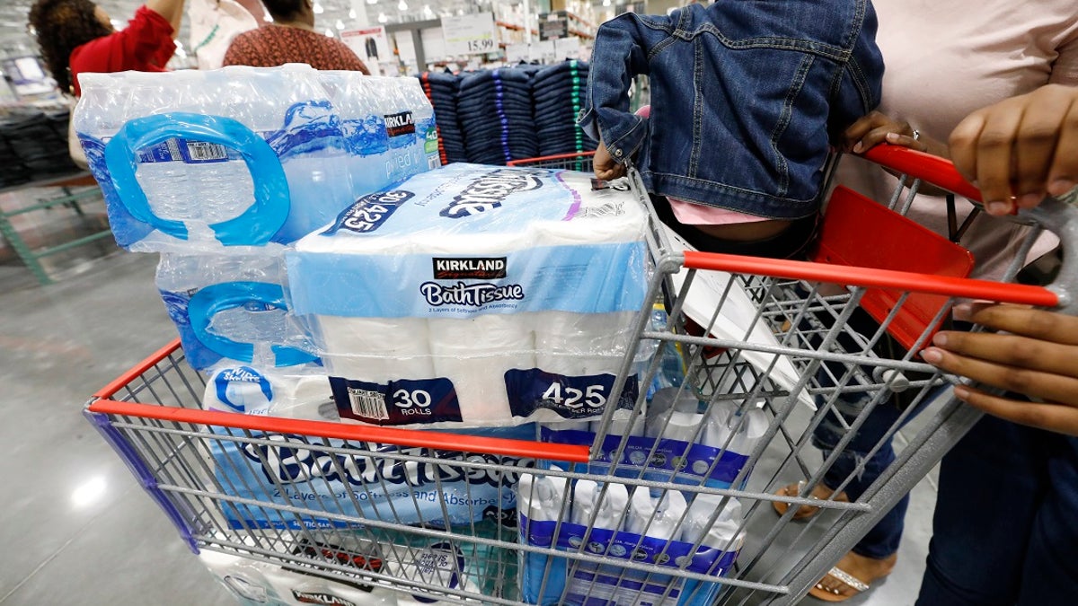 Customers take advantage of the grand opening of a new Costco store in Ridgeland, Miss., to stock up on water and bathroom tissue and cleaning supplies to help deal with coronavirus. (AP Photo/Rogelio V. Solis)