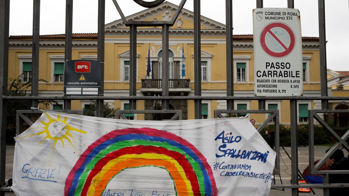In this March 14 photo, a banner reading "Everything will be alright" hangs on the main gate of the Spallanzani Hospital for Infectious Diseases, the Italian main hub for coronavirus treatment, in Rome, Italy. (AP Photo/Alessandra Tarantino)