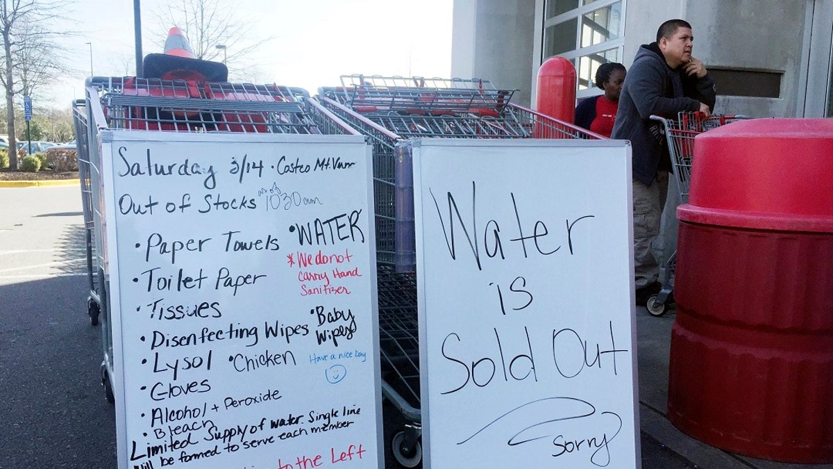 A sign outside a Costco warehouse store in Alexandria, Va., advises shoppers which items have sold out over the weekend. As fears of coronavirus grip the nation, Americans are rushing to stock up on staples and disinfectants. (AP Photo/Kevin S. Vineys)