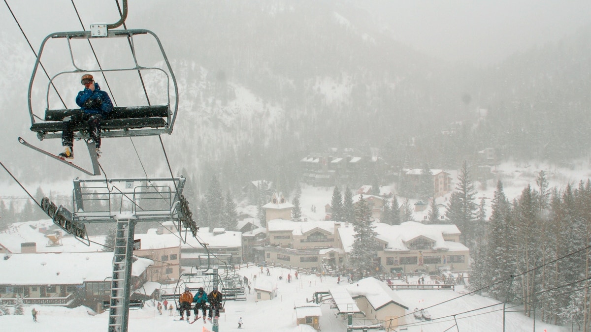 In this Feb. 21, 2008, file photo, skiers ride up Al's Run lift at the Taos Ski Valley, in Taos County, N.M. Some resorts are closing enclosed gondolas or aerial trams while others are encouraging skiers to ride lifts with only people they know as they adhere to social distancing guidelines. (AP Photo/Albuquerque Journal, File)