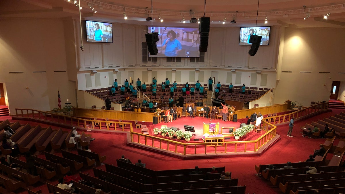 The choir sings during services on at St. Philip African Methodist Episcopal Church in Atlanta on Sunday, March 15, 2020. Only about 100 people filled a sprawling sanctuary that seats more than a thousand at the church because of coronavirus fears. Pastor William Watley told congregants he would follow officials' guidance on whether to continue services after Sunday, calling for prayer during the epidemic. (Jeff Amy/Associated Press)