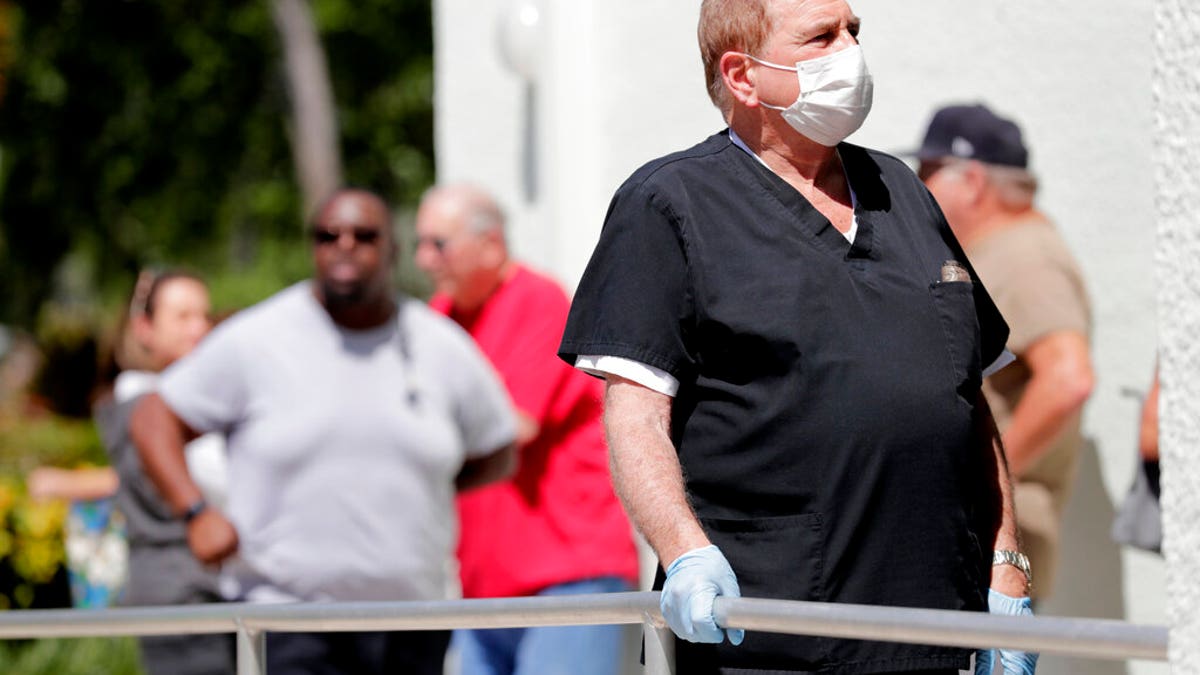 Harold Goodman waits in line to vote in the presidential primary election at the Supervisor of Elections office, Tuesday, March 17, 2020, in Delray Beach, Fla. This polling station was made available after some precincts in Palm Beach County were unable to open after poll workers did not report to work. (AP Photo/Lynne Sladky)