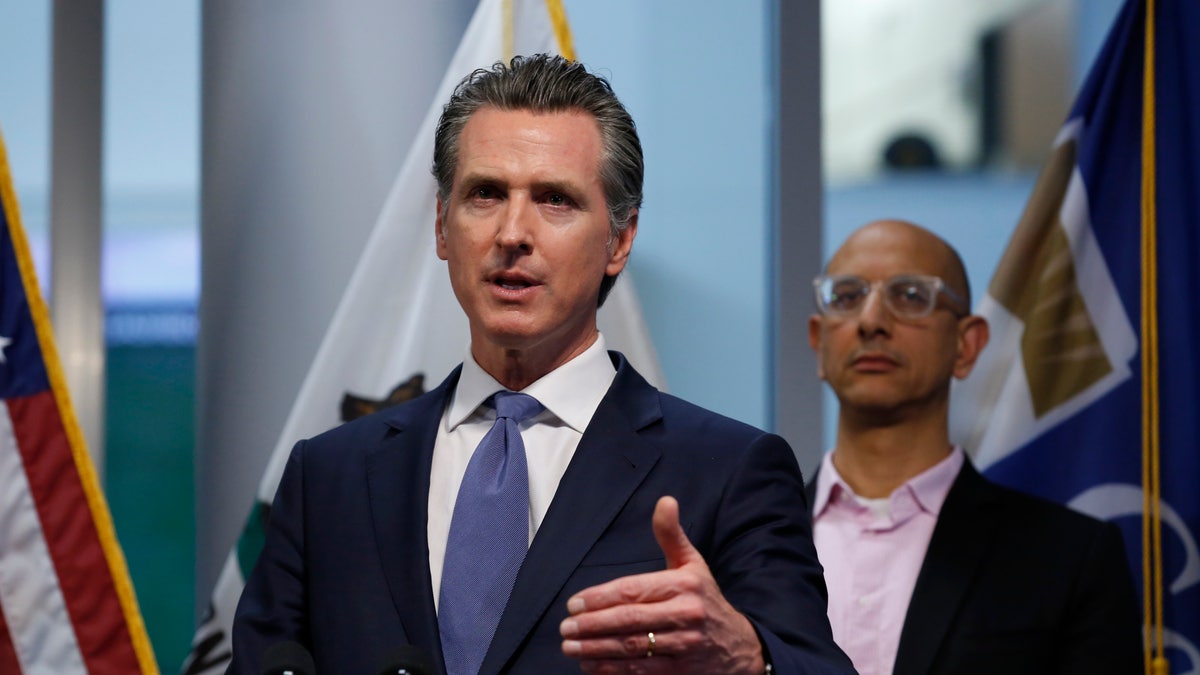 California Gov. Gavin Newsom updates the state's response to the coronavirus, at the Governor's Office of Emergency Services in Rancho Cordova Calif., Tuesday, March 17, 2020. At right is California Health and Human Services Agency Director Dr. Mark Ghaly. (AP Photo/Rich Pedroncelli, Pool)