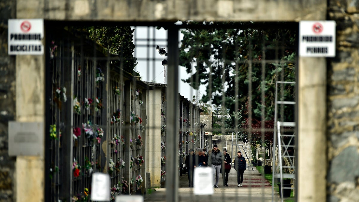 The municipal cemetery is closed except for limited burials, in Pamplona, northern Spain, Wednesday, March 18, 2020. Spain will mobilize 200 billion euros or the equivalent to one fifth of the country's annual output in loans, credit guarantees and subsidies for workers and vulnerable citizens, Prime Minister Pedro Sanchez announced Tuesday. (AP Photo/Alvaro Barrientos)