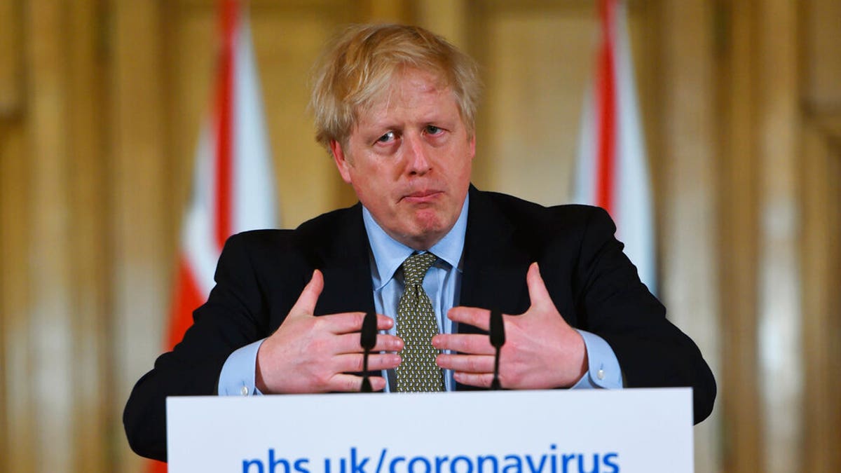 Britain's Prime Minister Boris Johnson speaks at a news conference regarding the coronavirus, in Downing Street, London, Wednesday, March 18, 2020. 