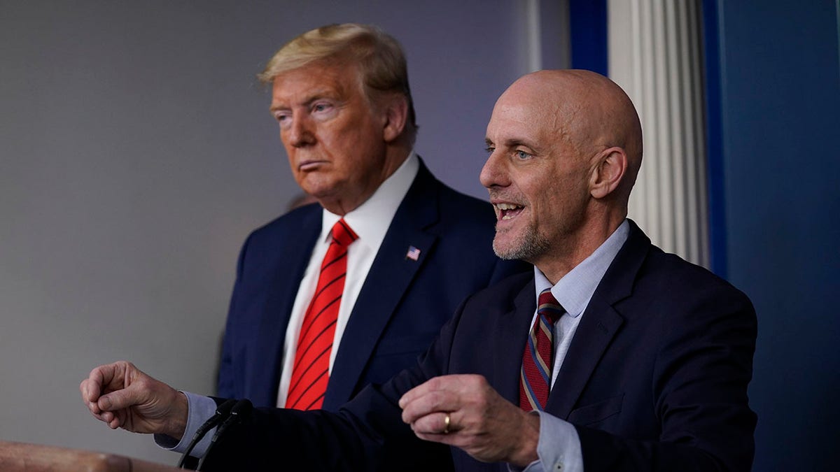 President Donald Trump, left, listens as Food and Drug Administration Commissioner Dr. Stephen Hahn speaks during a news briefing with the Coronavirus Task Force, at the White House, March 19, 2020, in Washington. (Associated Press)