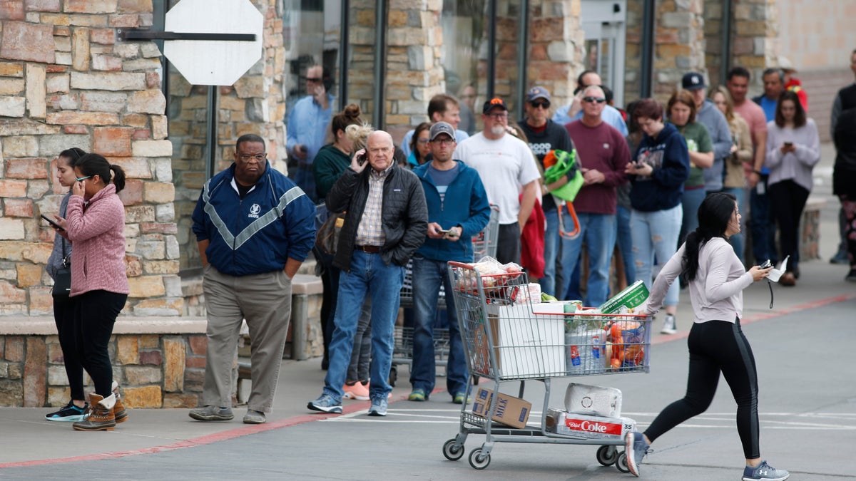 One shopper pulls her cart out of a Costco warehouse in Lone Tree, Colo. (AP Photo/David Zalubowski)