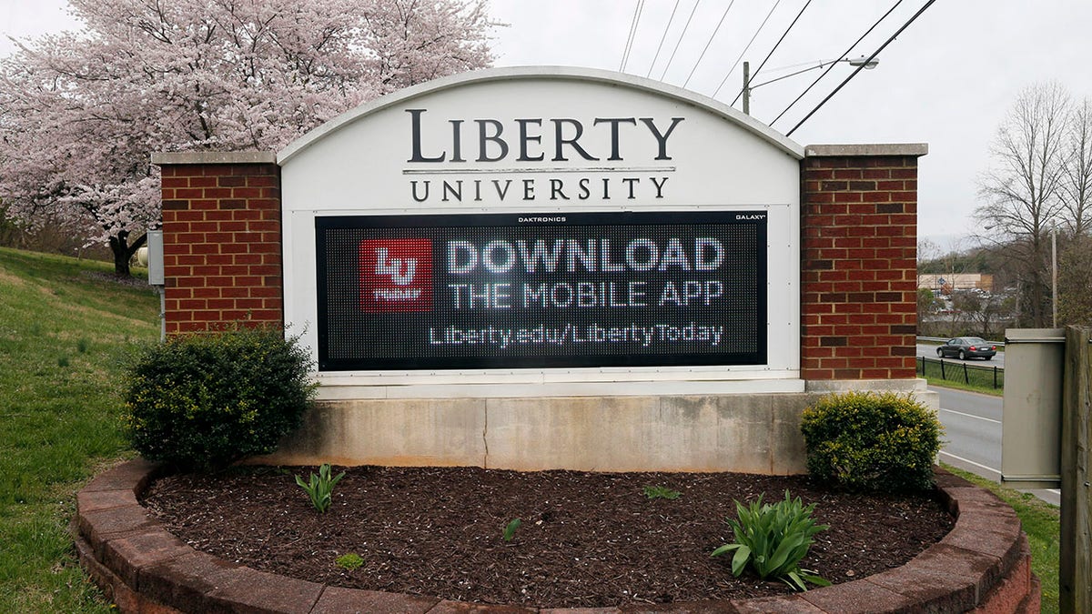 A sign marks the entrance to Liberty University, Tuesday March 24 , 2020, in Lynchburg, Va. Officials in Lynchburg said Tuesday they were fielding complaints and concerns about the hundreds of students that have returned from their spring break to Liberty University, where President Jerry Falwell Jr. has welcomed them back amid the coronavirus pandemic. (AP Photo/Steve Helber)