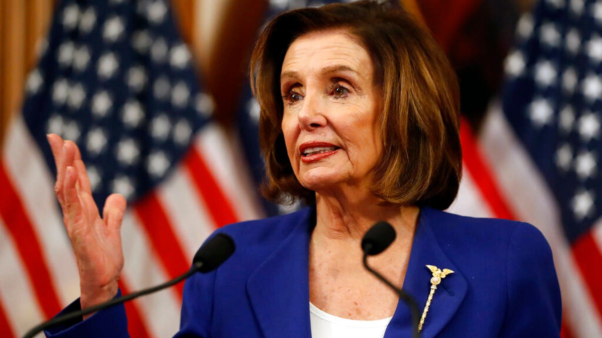 House Speaker Nancy Pelosi, D-Calif., speaks before she signs the Coronavirus Aid, Relief, and Economic Security (CARES) Act after it passed in the House on Capitol Hill, Friday, March 27, 2020. (AP Photo/Andrew Harnik)