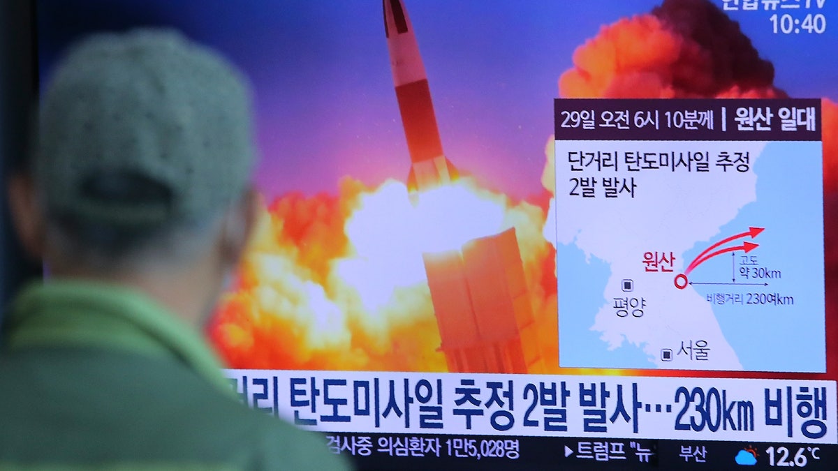 A man watches a TV screen showing a file image of North Korea's missile launch during a news program at the Seoul Railway Station in Seoul, South Korea, Sunday, March 29, 2020. North Korea on Sunday fired two suspected ballistic missiles into the sea, South Korea said, calling it "very inappropriate" at a time when the world is battling the coronavirus pandemic. The Korean letters read: " North Korea launched two suspected ballistic missiles into the sea." (AP Photo/Ahn Young-joon)