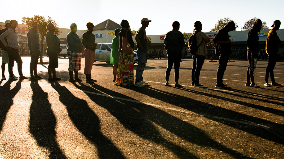 Pensioners queue for their social grant at a paypoint in Cape Town, South Africa, Monday, 30, 2020, as South Africa remained in a nationwide lockdown for 21 days in an effort to control the spread of the coronavirus. The virus causes mild or moderate symptoms for most people, but for some, especially older adults and people with existing health problems, it can cause more severe illness or death. (AP Photo)