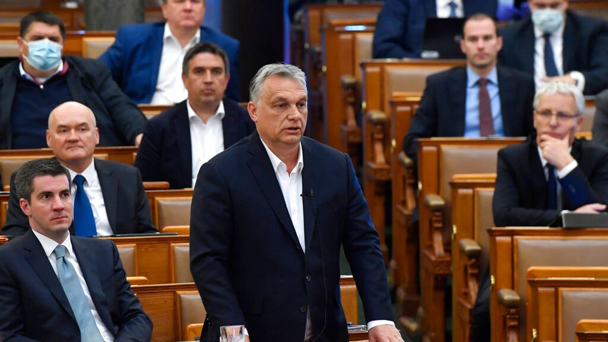 Hungarian Prime Minister Viktor Orban replies to faction leader of the oppositional Jobbik party Peter Jakab during a question and answer session of the Parliament in Budapest, Hungary, Monday, March 30, 2020. 