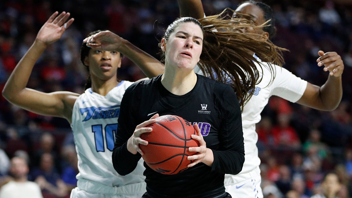 Portland's Alex Fowler (12) grabs a rebound over San Diego during the first half of an NCAA college basketball game in the final of the West Coast Conference women's tournament Tuesday, March 10, 2020, in Las Vegas. (AP Photo/John Locher)