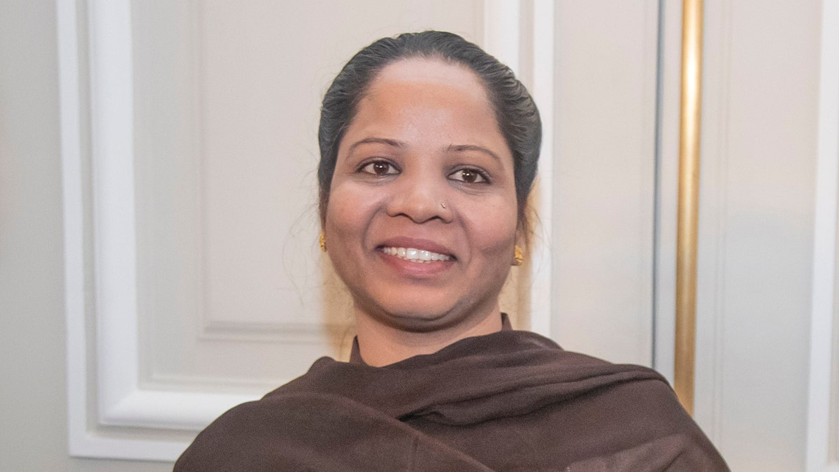 Asia Bibi, a Pakistani Christian woman, poses with her diploma as a Citizen of Honor of the city of Paris at City Hall in Paris, Tuesday, Feb. 25, 2020. Bibi, acquitted of blasphemy after spending eight years on death row in Pakistan, said she is going to request asylum in France. (AP Photo/Michel Euler)
