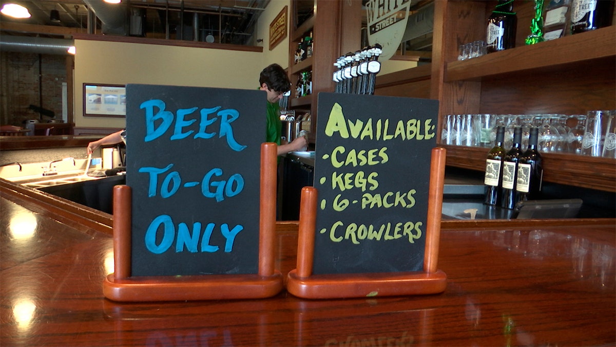 An employee at White Street Brewing Company in Wake Forest, N.C., fills a "crowler" can of beer on Tuesday, March 17. With bars ordered close due to coronavirus, brewers are making sure their customers can enjoy some fresh suds.