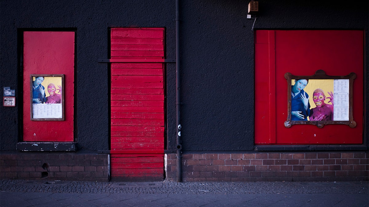 In this March 25, 2020, photo, signs are displayed near part of the front of the closed music club Wilde Renate, in Berlin, Germany. (AP Photo/Markus Schreiber)