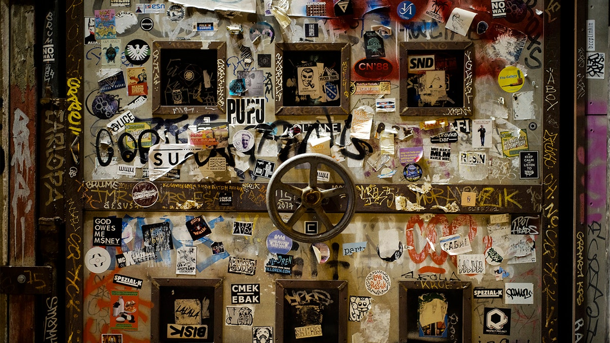 In this March 21, 2020, photo, stickers cover a door of the music clubs Sage and KitKatClub in Berlin, Germany. Berlin's nightclubs were closed March 13 to help slow the spread of the virus. (AP Photo/Markus Schreiber)