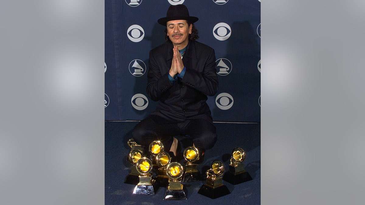 Musician Carlos Santana rejoices backstage with his Awards at the 42nd Annual Grammy Awards Show on Feb. 23, 2000, in Los Angeles, California.