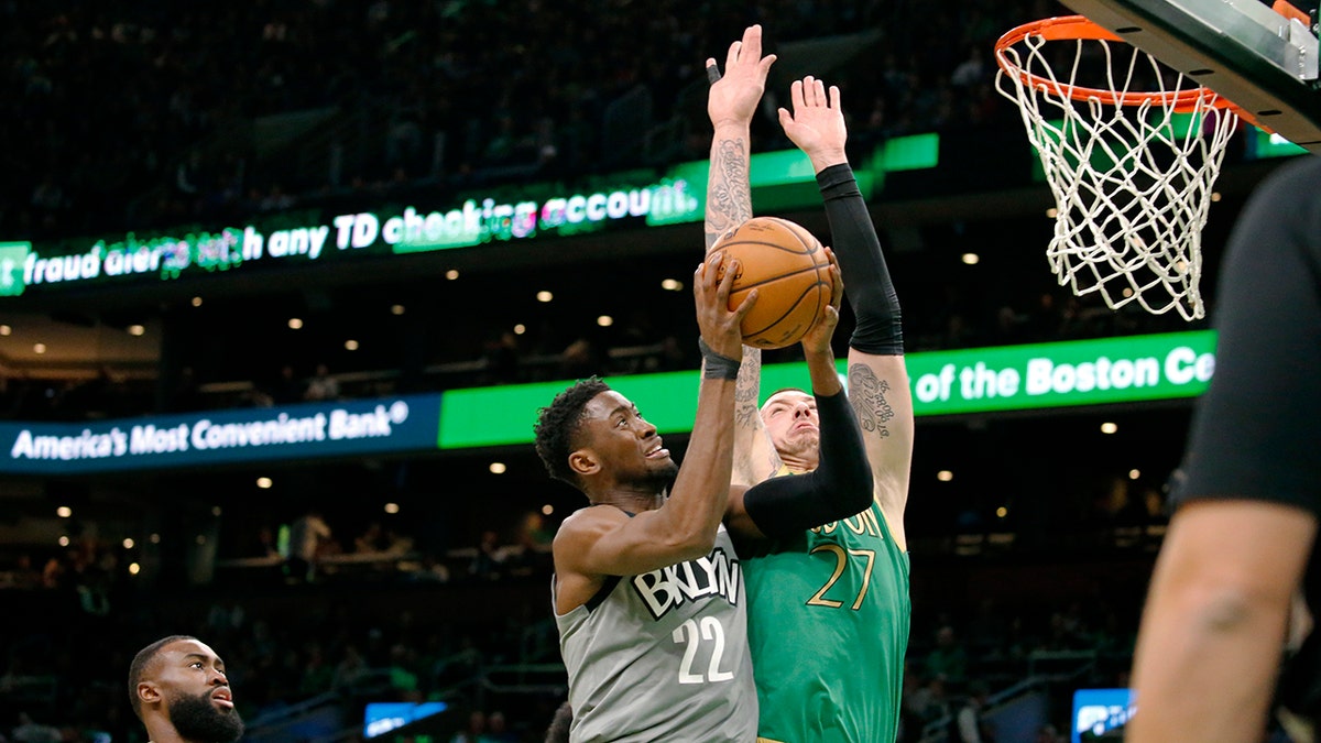 Brooklyn Nets guard Caris LeVert (22) drives to the basket against Boston Celtics' Daniel Theis during the first half of an NBA basketball game Tuesday, March 3, 2020, in Boston. (AP Photo/Mary Schwalm)