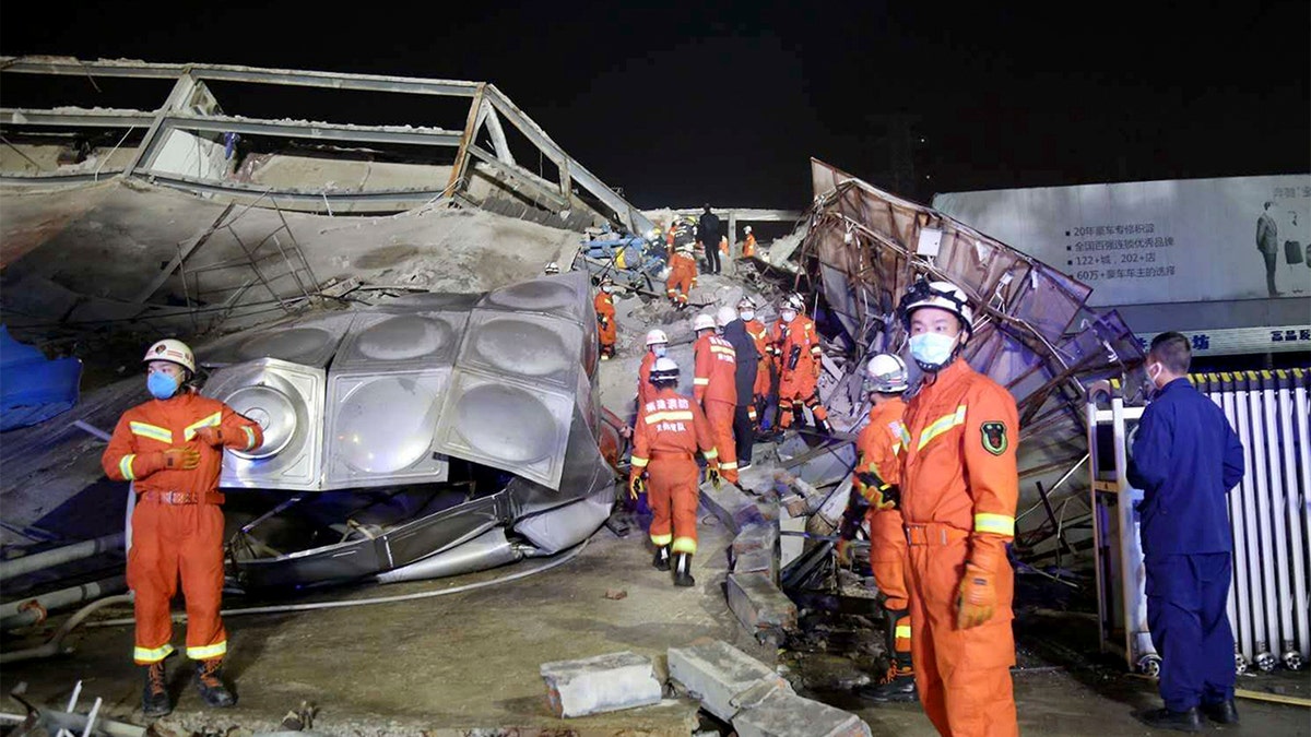 Rescuers work at the site of a collapsed five-story hotel building in Quanzhou city in southeast China's Fujian province Saturday, March 7, 2020. 