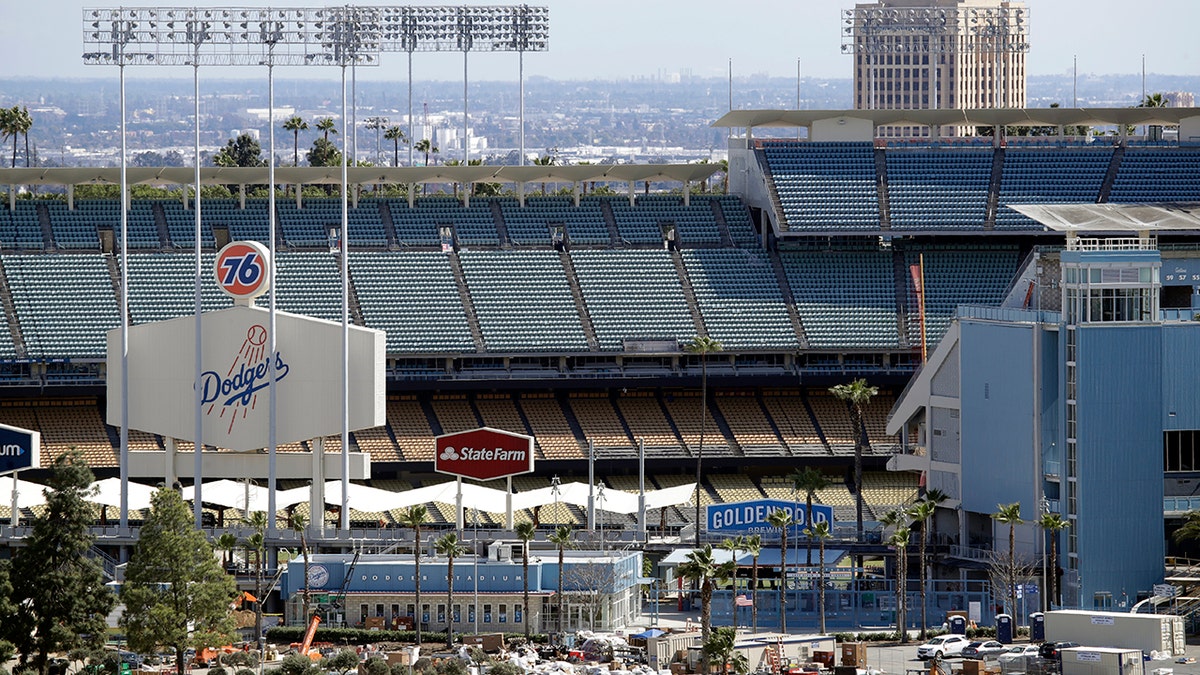The exterior of Dodgers Stadium, home of the Los Angeles Dodgers is seen Wednesday, March 25, 2020, in Los Angeles. There will be empty ballparks on what was supposed to be Major League Baseball's opening day, with the start of the Major League Baseball regular season indefinitely on hold because of the coronavirus pandemic. (AP Photo/Marcio Jose Sanchez)
