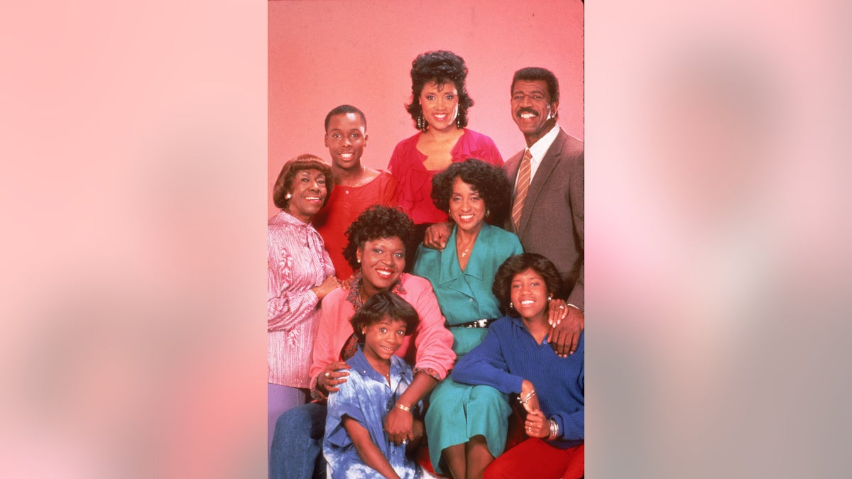 Promotional studio portrait of the cast of the television series '227,' circa 1985. L-R: Actors Helen Martin, Curtis Baldwin, Jackee Harry, Hal Williams. (Seated) Alaina Reed Hall, Marla Gibbs. (Front) Kia Goodwin and Regina King.