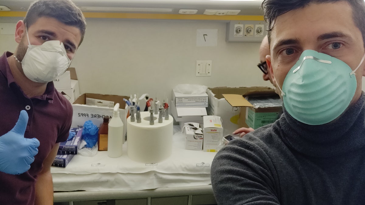 Alessandro Romaioli (left), and Cristian Fracassi (right) of Isinnova with their 3D-printed ventilator valves.