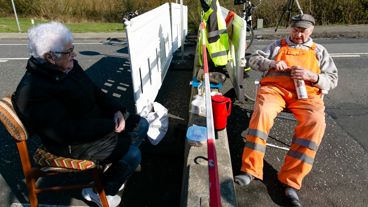 Rasmussen, left, and Hansen sit at the German-Danish border crossing in Aventoft on March 27. (Frank Molter/picture-alliance/dpa/AP Images)