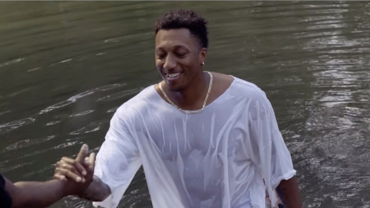 Lecrae gets baptized in the Jordan River.