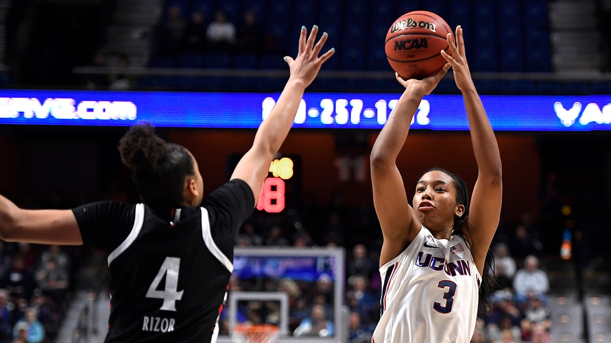 Connecticut's Megan Walker (3) shoots over Cincinnati's Angel Rizor (4) during the first half of an NCAA college basketball game in the American Athletic Conference tournament finals at Mohegan Sun Arena, Monday, March 9, 2020, in Uncasville, Conn. (AP Photo/Jessica Hill)