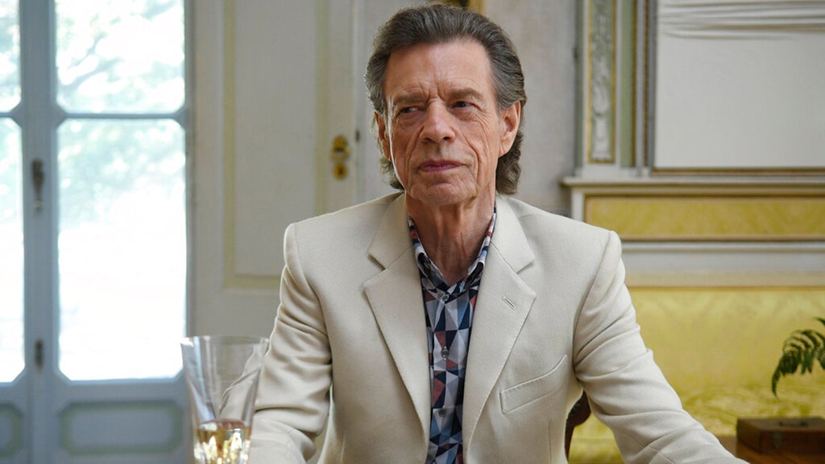 This image released by Sony Pictures Classics shows Mick Jagger in a scene from the film, "The Burnt Orange Heresy." Jagger plays a devilish art collector who cunningly convinces an art journalist to use a rare interview with a reclusive artist as an opportunity to steal one of his paintings. It’s Jagger’s first film since 2001’s “The Man From Elysian Fields.” (Jose Haro/Sony Pictures Classics via AP)
