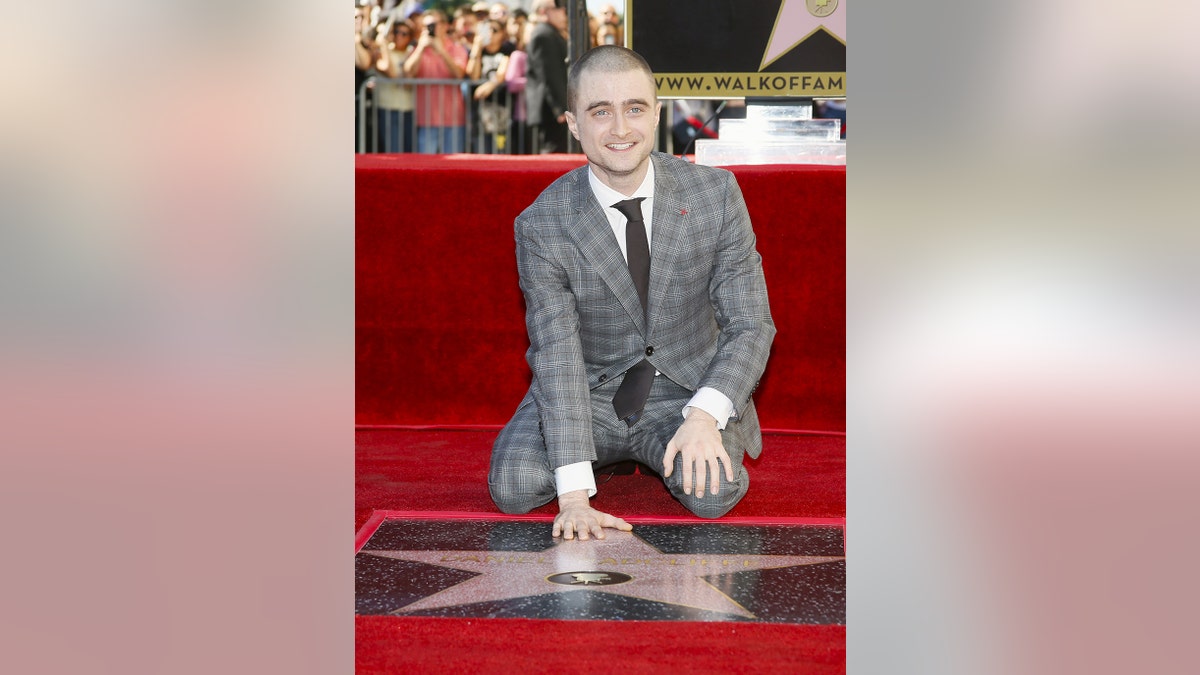 Actor Daniel Radcliffe poses during a ceremony honoring him with a star on the Hollywood Walk of Fame in Hollywood, California November 12, 2015.