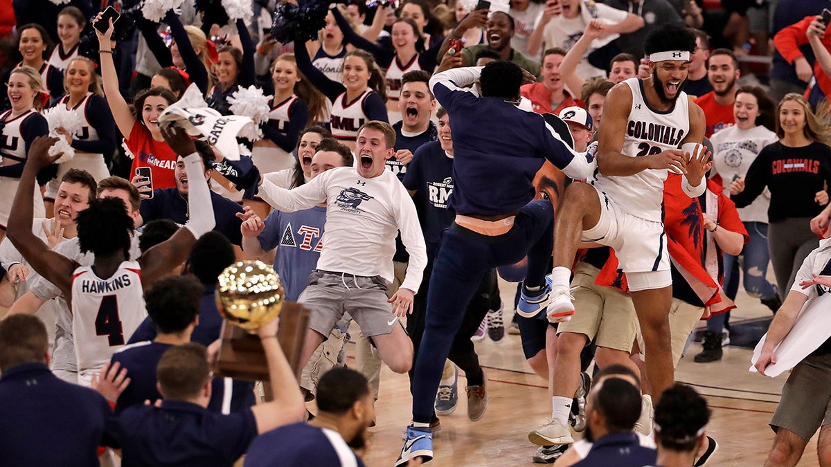 Robert Morris fans run onto the court as the team celebrates following a 77-67 win over St. Francis in an NCAA college basketball game for the Northeast Conference men's tournament championship in Pittsburgh, Tuesday, March 10, 2020. (AP Photo/Gene J. Puskar)