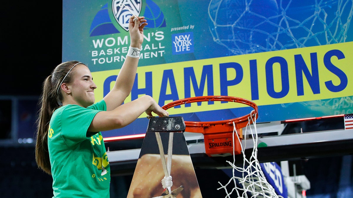 Oregon's Sabrina Ionescu (20) reacts while cutting down the net after defeating Stanford in an NCAA college basketball game in the final of the Pac-12 women's tournament Sunday, March 8, 2020, in Las Vegas. (AP Photo/John Locher)