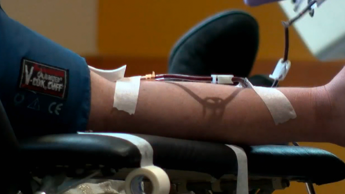 A donor giving blood at a blood drive.