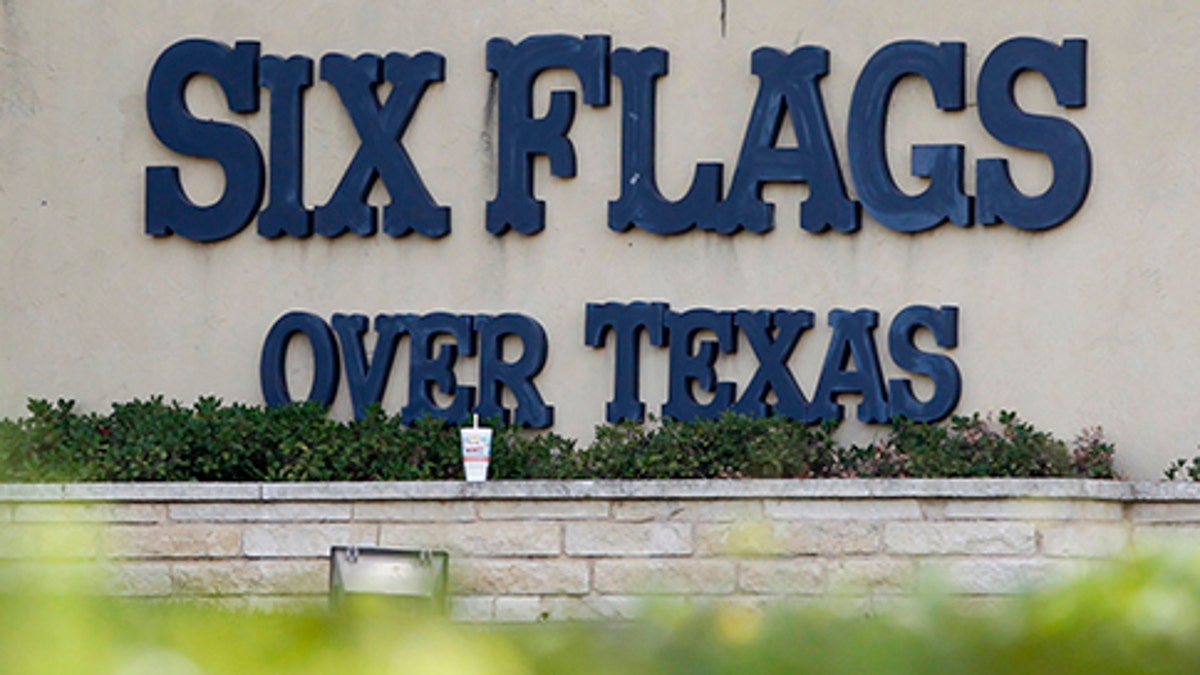 A sign at the entrance of the Six Flags Over Texas amusement park is seen in Arlington, Texas July 23, 2013. (Reuters)