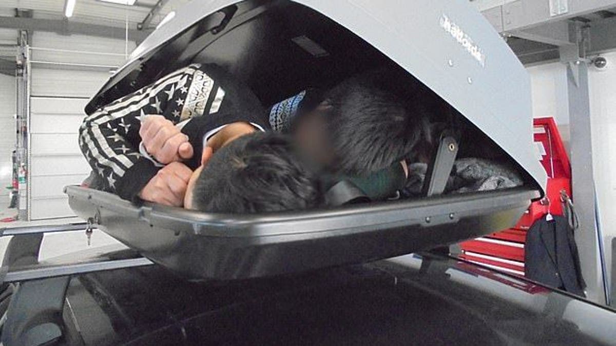 Three people can be seen crammed in the roof box on top of a car that was found in France on Oct. 5, 2019.