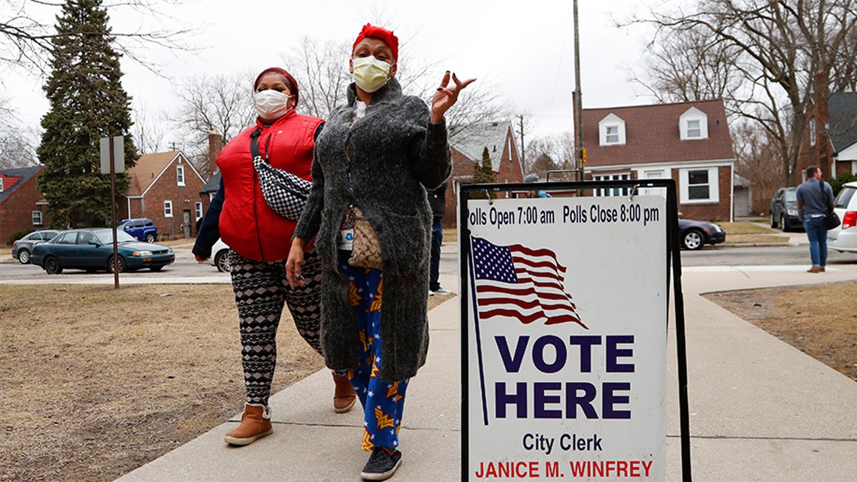 Voters arrive with masks in light of the coronavirus COVID-19 health concern at Warren E. Bow Elementary School in Detroit, Tuesday, March 10, 2020. (Associated Press)