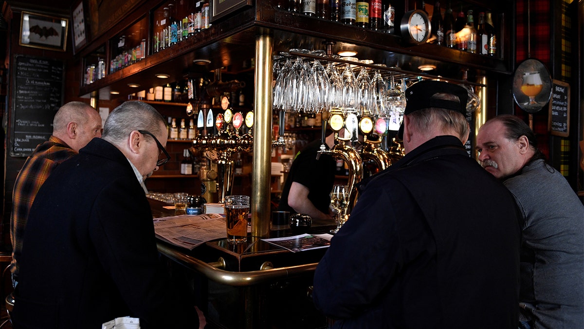 People gather for a drink at the Half Way In pub, as bars and restaurants are still open despite the coronavirus disease (COVID-19) outbreak, in central Stockholm, Sweden.