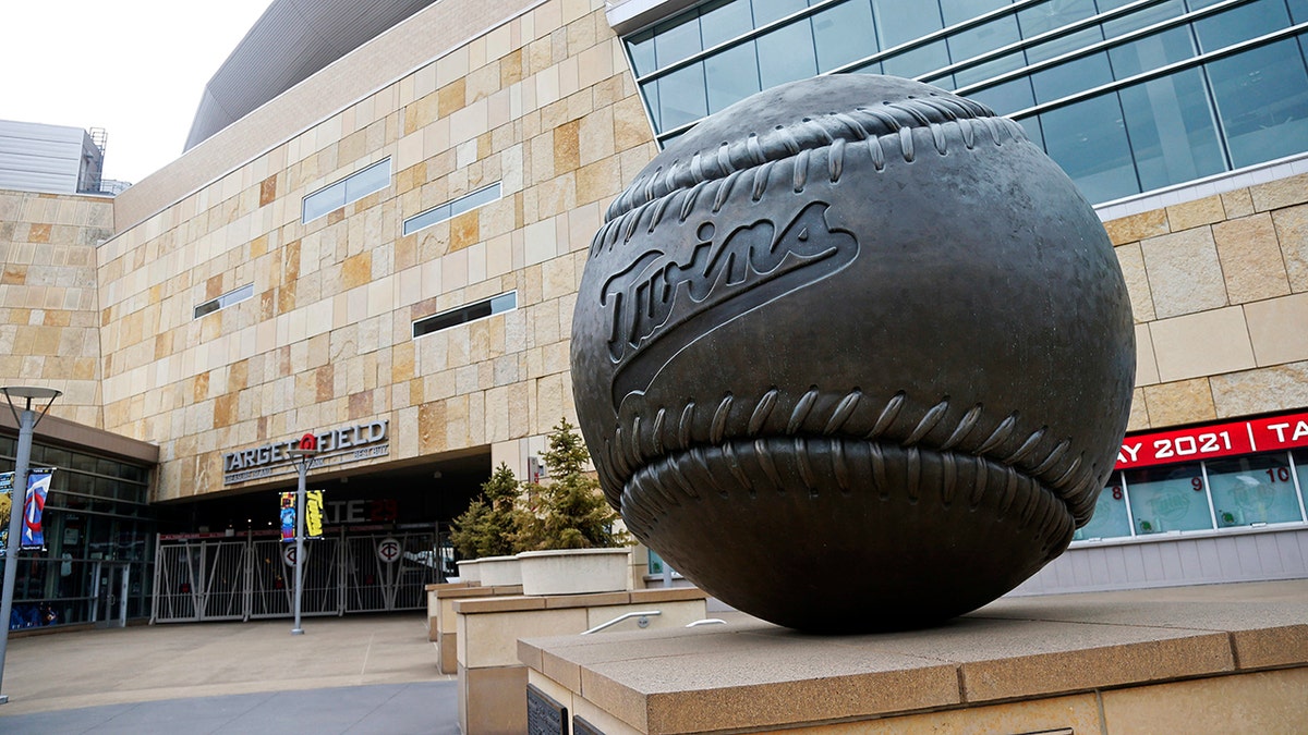 A giant baseball sculpture sits outside Target Field, home of the Minnesota Twins baseball team, Wednesday, March 25, 2020 in Minneapolis. Though the Twins would open on the road, the start of the regular season is indefinitely on hold because of the coronavirus pandemic. (AP Photo/Jim Mone)